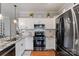 Stylish kitchen with white cabinets, subway tile backsplash, and modern stainless steel appliances at 4408 Overbecks Ln, Waxhaw, NC 28173