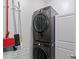 A convenient laundry room featuring a stacked washer and dryer at 4408 Overbecks Ln, Waxhaw, NC 28173