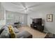 A comfortable living room featuring a gray sofa, desk, and large-screen TV at 4408 Overbecks Ln, Waxhaw, NC 28173
