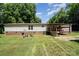 Backyard featuring a porch, garden, and a lush green lawn at 495 Brumley Rd, Mooresville, NC 28115
