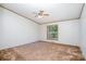 Cozy bedroom with neutral carpet, window, and ceiling fan at 495 Brumley Rd, Mooresville, NC 28115