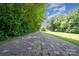 Long brick driveway lined with trees, leading to the home at 495 Brumley Rd, Mooresville, NC 28115