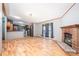 Bright living room featuring wood floors and a brick fireplace at 495 Brumley Rd, Mooresville, NC 28115