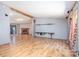Open-concept living room featuring wood floors and a brick fireplace at 495 Brumley Rd, Mooresville, NC 28115