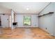 Open-concept living room featuring wood floors and large windows at 495 Brumley Rd, Mooresville, NC 28115