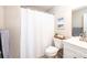 Bright bathroom featuring a shower with white curtain, vanity with sink, toilet, and minimalist decor at 50 Serenity Ln, Hickory, NC 28601