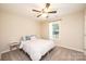 Cozy bedroom with carpet, ceiling fan, a large window, and neutral walls, offering relaxation at 50 Serenity Ln, Hickory, NC 28601