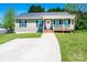 Inviting home showcasing a tidy front yard and cozy covered porch, perfect for relaxing at 50 Serenity Ln, Hickory, NC 28601