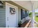 Close-up of a welcoming front porch with a decorated front door and cozy seating area at 50 Serenity Ln, Hickory, NC 28601