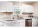 Well-appointed kitchen featuring white cabinets, a stainless steel dishwasher, and granite countertops at 50 Serenity Ln, Hickory, NC 28601