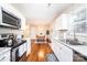 Efficient kitchen leading to the dining area, offering ample storage and stainless steel appliances at 50 Serenity Ln, Hickory, NC 28601