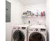 Well-lit laundry room featuring a washer, dryer, and storage shelf for detergent and other cleaning supplies at 50 Serenity Ln, Hickory, NC 28601