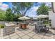 Spacious backyard patio featuring an outdoor kitchen, dining and seating areas, perfect for entertaining at 5501 Murrayhill Rd, Charlotte, NC 28210