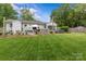Expansive backyard with outdoor kitchen, entertainment area, and lush lawn, providing ample room for leisure at 5501 Murrayhill Rd, Charlotte, NC 28210