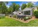 Beautiful backyard featuring a hot tub, patio, outdoor kitchen and lush green lawn at 5501 Murrayhill Rd, Charlotte, NC 28210