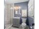 Updated bathroom features blue accent wall, glass enclosed shower, and modern vanity at 5501 Murrayhill Rd, Charlotte, NC 28210