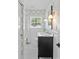 Bathroom featuring a black vanity, geometric wallpaper, a window, and a tub/shower combo at 5501 Murrayhill Rd, Charlotte, NC 28210