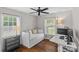Bright bedroom with hardwood floors, daybed, and lots of natural light from two windows at 5501 Murrayhill Rd, Charlotte, NC 28210