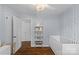 Light and airy Bedroom with a crib, and cute wallpaper with silver sparkles and a bright sunny window at 5501 Murrayhill Rd, Charlotte, NC 28210