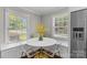 Cozy breakfast nook featuring built-in seating, a round table, and natural lighting at 5501 Murrayhill Rd, Charlotte, NC 28210