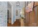 Entryway with wood door, wood floors, decoratively papered walls, and overhead lighting at 5501 Murrayhill Rd, Charlotte, NC 28210