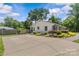 Ranch style home with large parking pad and well manicured landscaping at 5501 Murrayhill Rd, Charlotte, NC 28210