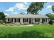 Charming one-story home with white painted brick, black shutters and professionally landscaped front yard at 5501 Murrayhill Rd, Charlotte, NC 28210