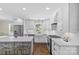 Open-concept kitchen with white cabinets, a farmhouse sink, stainless steel appliances, and a center island at 5501 Murrayhill Rd, Charlotte, NC 28210