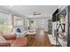 Open-concept living room featuring hardwood floors, gray walls, and updated furniture at 5501 Murrayhill Rd, Charlotte, NC 28210