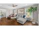 Living room with wood floors, gray walls, and large windows overlooking a verdant landscape at 5501 Murrayhill Rd, Charlotte, NC 28210