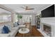 Open-concept living room with hardwood floors, gray walls, and a ceiling fan at 5501 Murrayhill Rd, Charlotte, NC 28210