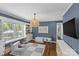 Cozy playroom with blue walls, built-in shelving, and lots of natural light from a large window at 5501 Murrayhill Rd, Charlotte, NC 28210
