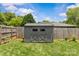 Backyard shed with a gray exterior and a metal roof at 5501 Murrayhill Rd, Charlotte, NC 28210