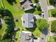 Aerial view of home with grey roof, backyard, patio and manicured landscaping at 5822 Parkstone Dr, Matthews, NC 28104
