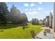Backyard view with green grass, playset, patio and landscaped yard at 5822 Parkstone Dr, Matthews, NC 28104