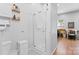 Bathroom with toilet, shower, storage and view into the dining room with table and chairs at 5822 Parkstone Dr, Matthews, NC 28104