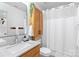 Stylishly updated bathroom featuring a modern vanity, sleek fixtures, and a tub with a white shower curtain at 5822 Parkstone Dr, Matthews, NC 28104