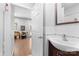 Well-lit bathroom with classic tiling, updated fixtures, and a view into an adjacent dining area at 5822 Parkstone Dr, Matthews, NC 28104