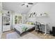 Bright bedroom features a large window, modern décor, and streamlined shelving, great for relaxing and studying at 5822 Parkstone Dr, Matthews, NC 28104