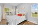 Inviting bedroom with large windows, a cozy bed, wood floors, and ample natural light throughout the space at 5822 Parkstone Dr, Matthews, NC 28104
