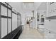 Bright entryway featuring a coat rack with seating, a staircase, and an open view into the living area at 5822 Parkstone Dr, Matthews, NC 28104