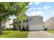 Charming two-story home with a well-manicured lawn, a two-car garage, and a covered front porch at 5822 Parkstone Dr, Matthews, NC 28104