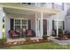 Home featuring inviting front porch with seating, tasteful decor and manicured landscaping at 5822 Parkstone Dr, Matthews, NC 28104