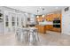 Eat-in kitchen with stainless steel appliances, an island, wooden cabinetry, tile backsplash, and bay windows at 5822 Parkstone Dr, Matthews, NC 28104