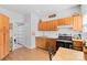 Traditional kitchen with warm wood cabinetry, modern appliances, granite countertops, and an adjacent dining area at 5822 Parkstone Dr, Matthews, NC 28104