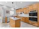 Bright kitchen with stainless steel appliances, granite countertops, an island, tile flooring, and ample cabinet space at 5822 Parkstone Dr, Matthews, NC 28104