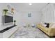 Bright living room with neutral colors, modern decor, and a large area rug over tile flooring at 5822 Parkstone Dr, Matthews, NC 28104