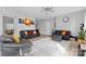 Cozy living room featuring modern furnishings, a ceiling fan, and neutral paint colors with natural light at 5822 Parkstone Dr, Matthews, NC 28104