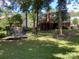Expansive backyard featuring mature trees, a deck, and a trampoline, offering plenty of space for outdoor activities at 6632 Summer Darby Ln, Charlotte, NC 28270