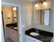 Bright bathroom with black granite countertops and white cabinets offers ample storage at 6632 Summer Darby Ln, Charlotte, NC 28270